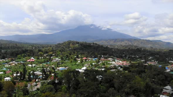 Aerial View Flying Over a Forested Rural Village in Tanzania