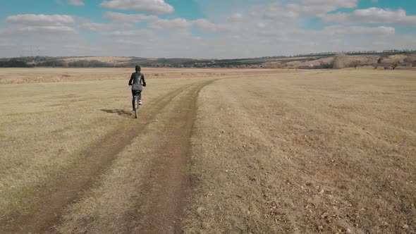 Aerial View of a Cyclist Riding on His Bicycle on Road at Nature.