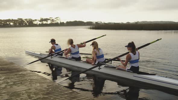 Female rowing team training on a river