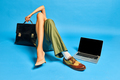 Male and female legs in boots and heels with briefcase and laptop on blue studio background - PhotoDune Item for Sale