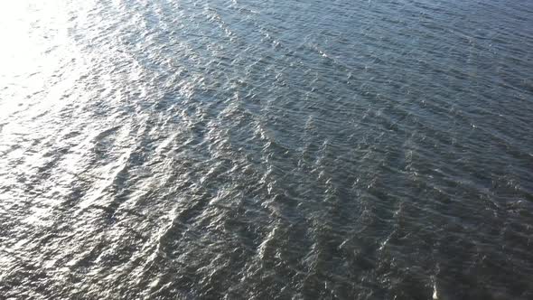 An aerial view of Hempstead Bay during a windy, winter day. The camera dolly in, tilted down then ti