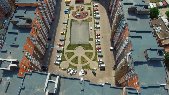 Top down view of infrastructure of a modern residential area. Modern place with parked cars between 
