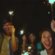 Celebrates with sparklers lights in camping on summer beach at night - VideoHive Item for Sale