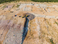 Aerial view from above of dumping site. Garbage trucks. Yellow tractor. Waste sorting. Landfill of - PhotoDune Item for Sale