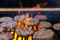 On the hot grill, a barbecued American beef burger is being grilled on the flames - PhotoDune Item for Sale