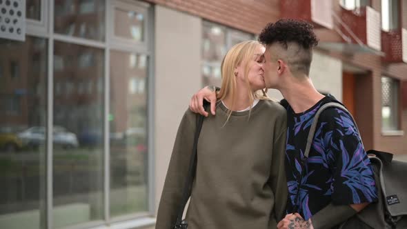 Young stylish people kissing on the background of the cityscape