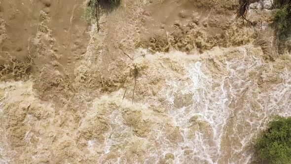 Aerial view of dirty river with muddy water in flooding period during heavy rains in spring.