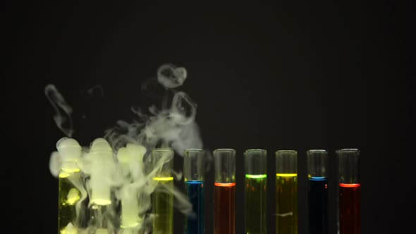 Multicolor Liquids in Test Tubes Emitting Smoke in Dark Laboratory, Narcotic