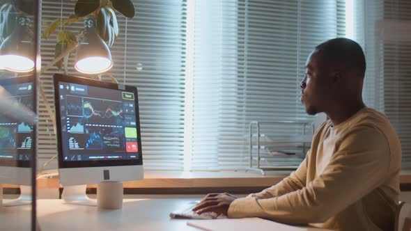 African American Man Working with Financial Data at Night