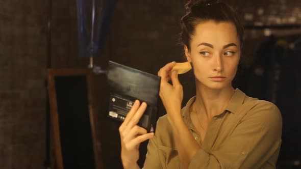 Woman Sponging a Foundation on Her Face