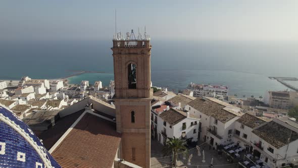 Blue domed hilltop church on Spain's Costa Blanca, Altea; aerial arc