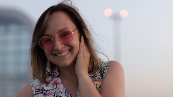 Happy Woman Tourist in Pink Sunglasses Dancing and Listening To Music in Earphones. Moving in Dance