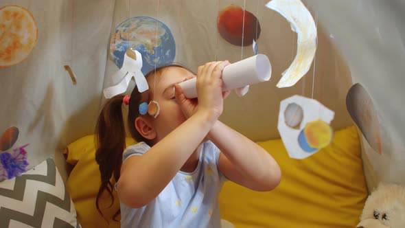 Cute Preschool Girl is Exploring Planets and Space By Playing Games at Home