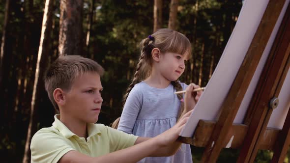 Happy Family Boy and Girl Drawing Coloring Picture with Brush Helping Cute Child Daughter Enjoying