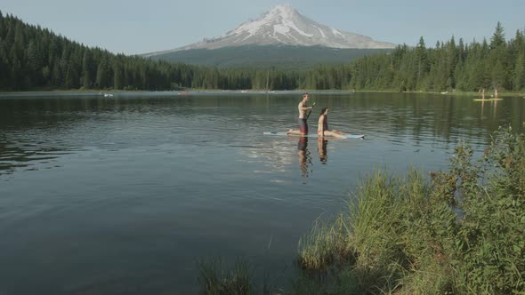 Couple paddleboarding near Mount Hood, USA