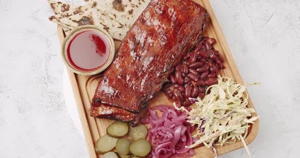 A Large Plate That Includes Baby Back Ribs with Cherry Chipotle Sauce