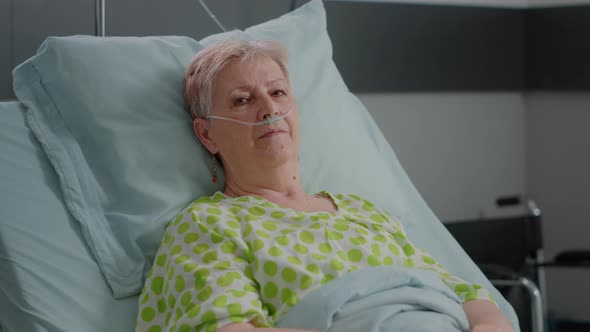 Close Up of Elder Woman Sitting in Hospital Ward Bed