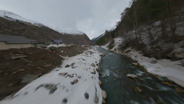 Aerial Cinematic View Fpv Sport Drone Flying Over Nature Rocky Snowy Peaks Scenery and Narrow River