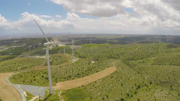 Wind Turbines Producing Alternative Green Energy for Modern Plant or Factory