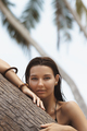Tanned Woman in Black Bikini on the Summer Beach Near Palm Tree - PhotoDune Item for Sale