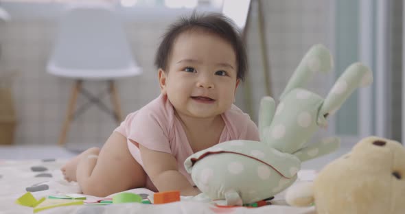 Happy Adorable Asian Baby Lying And Sitting On The Floor. Baby Development.