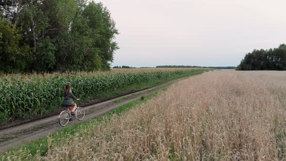 Woman on Bicycle in Countryside