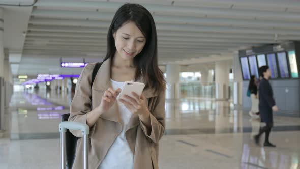 Woman use of mobile phone in airport 