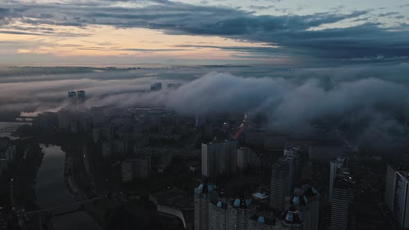 Aerial View of a Big Dark City Evening Traffic After Sunset Rainy Weather Highrise Buildings and