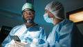 Doctor uses smartphone in surgery room - PhotoDune Item for Sale
