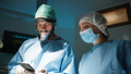 Doctor uses smartphone in surgery room - PhotoDune Item for Sale