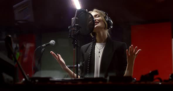 Beautiful Woman Sings a Love Song in Recording Studio