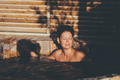 Young woman relaxing in wooden hot tub outdoor. - PhotoDune Item for Sale
