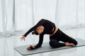 Young woman instructor perform simplified pigeon pose and hold side tilt. - PhotoDune Item for Sale