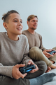 Father with teenage son playing video games on console use joystick controller. - PhotoDune Item for Sale