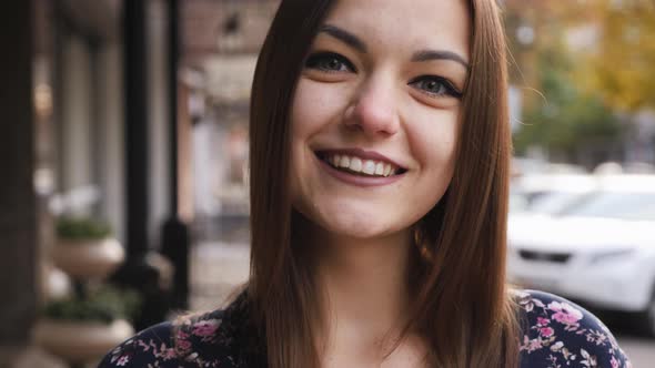 Close-up Portrait of Young Beautiful Businesswoman Looking at Camera, Happy and Smile on the Street