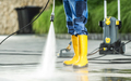A Men Washing Residential Bricks Made Driveway and Paths Using Powerful Pressure Washer.  - PhotoDune Item for Sale