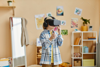 Schoolboy in vr headset standing in front of camera in home environment