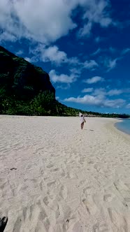 Tropical Beach with Palm Trees and White Sand Blue Ocean and Beach Beds with umbrellaSun Chairs and