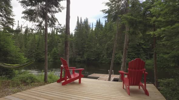 adirondak cottage chairs at lake side dock slider view 4k