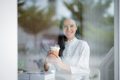 Portrait of a young woman with a smiling face in a coffee shop. - PhotoDune Item for Sale