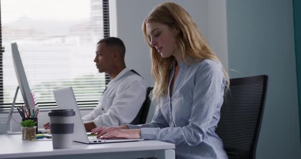 Man and woman working on computers