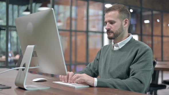 Ambitious Young Man Working on Computer