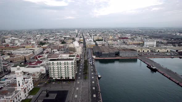 backwards drone shot of the main port of veracruz and its surroundings