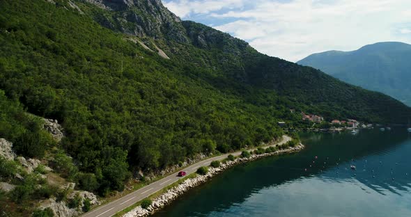 Road in Mountains Along the Crystal Clear Lake