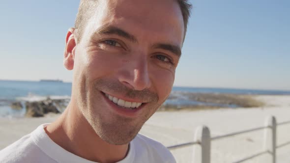 Portrait of a young man smiling on a beach