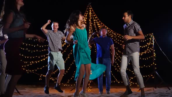 People Dancing on Night Beach Party