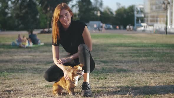 Young Beautiful Woman in the Park with Her Funny Longhaired Chihuahua Dog