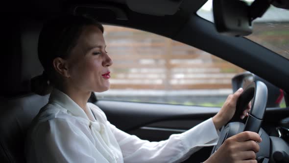 Businesswoman Talking on In-car Speakerphone