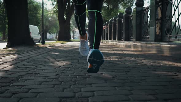 Closeup Female Feet Running on Sidewalk in Slow Motion