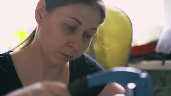 Serious Woman Works with Special Metal Press Machine